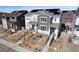 Aerial view of a modern townhouse with gray siding and solar panels on the roof at 8211 Monte Vista Cir, Littleton, CO 80125