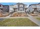 Charming townhouse with gray siding, stone accents, and well-maintained landscaping at 8211 Monte Vista Cir, Littleton, CO 80125