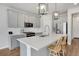 Modern kitchen featuring gray cabinets, stainless steel appliances, and a large center island at 8211 Monte Vista Cir, Littleton, CO 80125