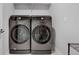 Laundry room with modern Samsung washer and dryer units at 8211 Monte Vista Cir, Littleton, CO 80125