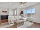 A living room with a large window and great views, a white sofa, and an adjacent entryway at 8211 Monte Vista Cir, Littleton, CO 80125