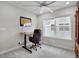 Inviting office features a ceiling fan, adjustable desk, and a large window offering plenty of natural light at 8211 Monte Vista Cir, Littleton, CO 80125