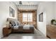 Comfortable bedroom with exposed brick wall, large window, and modern decor at 1435 Wazee St # 305, Denver, CO 80202
