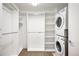 Organized closet with built-in shelving and a stacked washer/dryer unit at 1435 Wazee St # 305, Denver, CO 80202