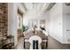 Elegant dining room with a rustic wooden table, stylish chairs, exposed brick wall, and abundant natural light at 1435 Wazee St # 305, Denver, CO 80202