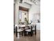Cozy dining area features a rustic wooden table, chic chairs, and large windows with picturesque views at 1435 Wazee St # 305, Denver, CO 80202