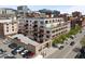 View of a well-maintained condo building with parking, balconies, and surrounding cityscape at 1435 Wazee St # 305, Denver, CO 80202