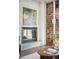 Close up on a modern fireplace featuring a brick accent wall and contemporary decor at 1435 Wazee St # 305, Denver, CO 80202