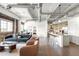 Bright, modern living room with exposed ductwork, brick accent wall and open concept kitchen at 1435 Wazee St # 305, Denver, CO 80202