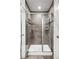 Sleek walk-in shower with gray tiled walls and a frameless glass door at 1435 Wazee St # 305, Denver, CO 80202