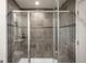 Walk-in shower featuring sleek gray tile, rainfall shower head, and glass door enclosure at 1435 Wazee St # 305, Denver, CO 80202