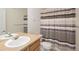 Bathroom with striped shower curtain, tile countertop, and large mirror at 22675 E Ontario Dr # 202, Aurora, CO 80016