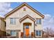 Inviting front entrance with an orange door and stone accents on a bright day at 22675 E Ontario Dr # 202, Aurora, CO 80016