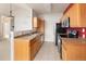 Galley kitchen with tile floor, stainless steel appliances, and wooden cabinets at 22675 E Ontario Dr # 202, Aurora, CO 80016