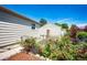 Beautiful backyard featuring lush greenery, colorful flowers, and fencing at 2268 Jay St, Edgewater, CO 80214