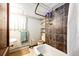 Bathroom with retro-style tile accents, fixtures, and updated bath tub at 2268 Jay St, Edgewater, CO 80214