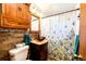 Bathroom with updated vanity, rustic wood detail, and decorative shower curtain at 2268 Jay St, Edgewater, CO 80214