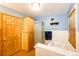 Bright bathroom with bathtub, tiled shower, tiled flooring, and vanity storage at 2268 Jay St, Edgewater, CO 80214