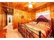 Wood-paneled main bedroom with patterned bedspread, ceiling fan, and natural light at 2268 Jay St, Edgewater, CO 80214