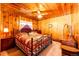 Wood-paneled bedroom with patterned bedspread, ceiling fan, and natural light at 2268 Jay St, Edgewater, CO 80214