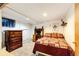 Bedroom featuring a work station, dresser, and bed with colorful quilt at 2268 Jay St, Edgewater, CO 80214