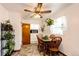 Bright dining room with wood table, chair set, decorative fan, large window, and decorative hanging plants at 2268 Jay St, Edgewater, CO 80214