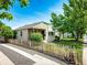 Charming home with a manicured front yard, complemented by a picket fence and mature trees at 2268 Jay St, Edgewater, CO 80214