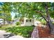 Landscaped front yard with lush grass, mature trees providing shade, and a welcoming curb appeal at 2268 Jay St, Edgewater, CO 80214