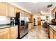 Spacious kitchen featuring stainless steel refrigerator and wooden cabinets at 2268 Jay St, Edgewater, CO 80214