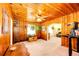 Living room featuring wood-paneled walls, a ceiling fan, natural light, and hanging plants at 2268 Jay St, Edgewater, CO 80214