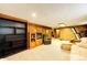 Living room with wood-paneled walls, neutral carpet, and a comfortable seating area at 2268 Jay St, Edgewater, CO 80214