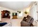 Spacious living room with carpet, natural light, sofa, recliner seating, television, and plants at 2268 Jay St, Edgewater, CO 80214
