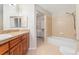Bathroom featuring a shower-tub combo, tiled floor, and a granite vanity at 8623 E Dry Creek Rd # 423, Englewood, CO 80112