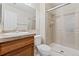 Bathroom featuring a tiled shower with glass doors, and wood vanity at 8623 E Dry Creek Rd # 423, Englewood, CO 80112