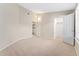A carpeted bedroom with an attached laundry room and closet for ease of living at 8623 E Dry Creek Rd # 423, Englewood, CO 80112
