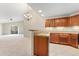 Open concept kitchen featuring wooden cabinets and granite countertops with a view to the living room at 8623 E Dry Creek Rd # 423, Englewood, CO 80112