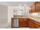 An open-concept kitchen with stainless steel dishwasher and views to living area at 8623 E Dry Creek Rd # 423, Englewood, CO 80112