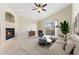 Bright living room featuring a fireplace, ceiling fan, and sliding glass doors to the outside at 8623 E Dry Creek Rd # 423, Englewood, CO 80112