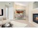 Open-concept space with fireplace, dining area with chandelier, and a view of the kitchen at 8623 E Dry Creek Rd # 423, Englewood, CO 80112
