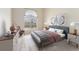 Primary bedroom with large window, modern decor, accent furniture and stylish artwork at 8623 E Dry Creek Rd # 423, Englewood, CO 80112