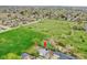 Aerial view of the property and surrounding neighborhood, highlighting the large grassy field nearby at 215 Jay St, Lakewood, CO 80226