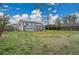 Backyard featuring a deck, patio, lawn, and mature trees at 215 Jay St, Lakewood, CO 80226