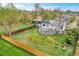 Aerial view of the backyard featuring a deck, patio, lawn, firepit, and wooden fence at 215 Jay St, Lakewood, CO 80226