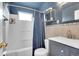 Small bathroom features a tub shower, vanity with gold faucet and a mirror at 215 Jay St, Lakewood, CO 80226