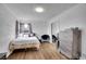 Cozy bedroom with hardwood flooring, a large window and stylish modern decor at 215 Jay St, Lakewood, CO 80226