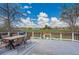 Outdoor deck featuring a dining table and chairs with views of a grassy field and blue skies at 215 Jay St, Lakewood, CO 80226
