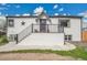 Charming home with a white exterior, black trim, and a welcoming front porch with stairs at 215 Jay St, Lakewood, CO 80226
