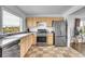 Updated kitchen features modern stainless steel appliances, stone countertops, and ceramic tile flooring at 215 Jay St, Lakewood, CO 80226