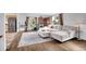 Bright living room with a cozy couch, area rug, hardwood floors, and a brick feature wall at 215 Jay St, Lakewood, CO 80226