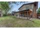Spacious backyard showcasing the patio area and a lush lawn with mature trees at 17390 E Greenwood Cir, Aurora, CO 80013
